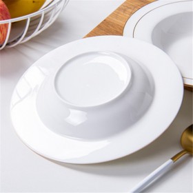 white ceramic plates with gold trim