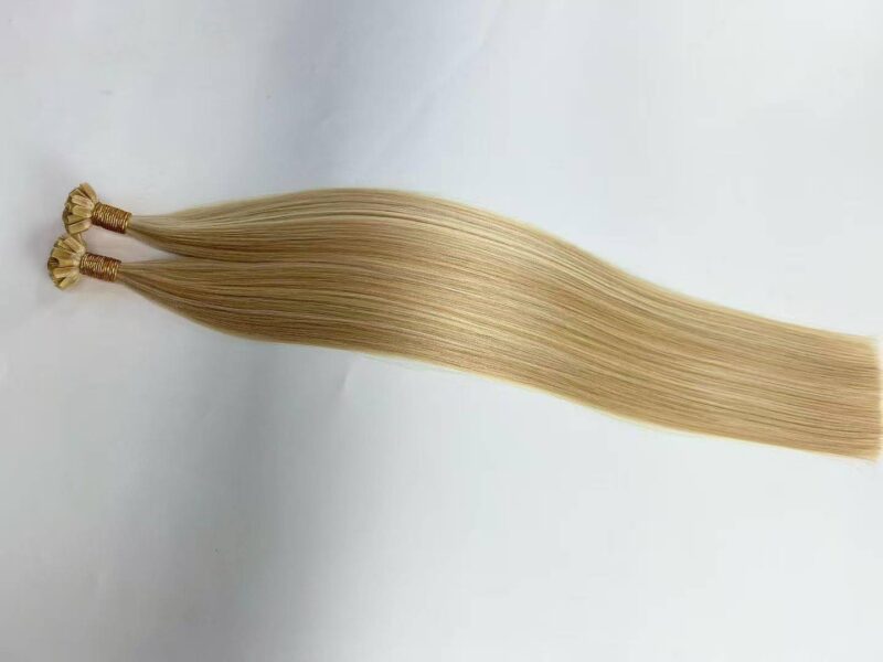 Close-up of keratin fusion human hair extensions highlighting the strong u-shaped bonds for seamless application.