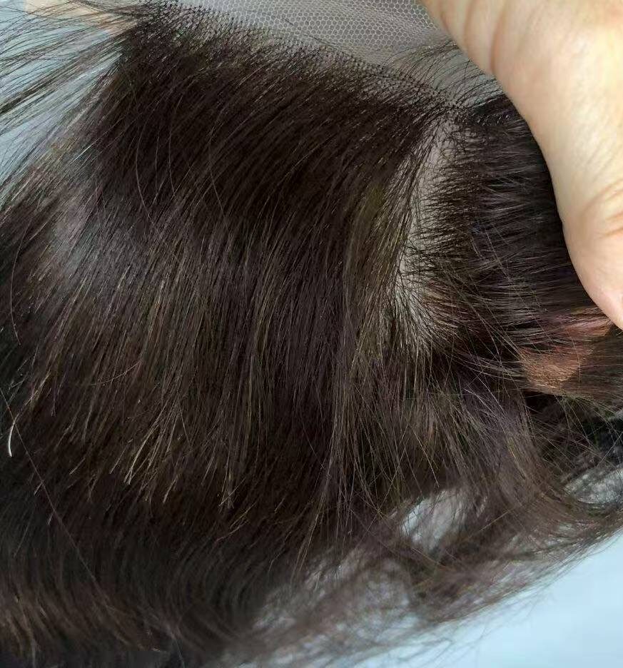 Top view of raw materials strictly supplied for manufacturing custom human hair wigs lace frontal units in high-end salons.
