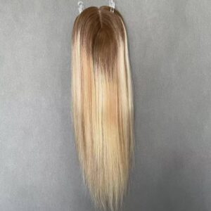 Top view of premium european human hair toppers featuring a rooted blonde balayage, supplied directly for salon wholesale.