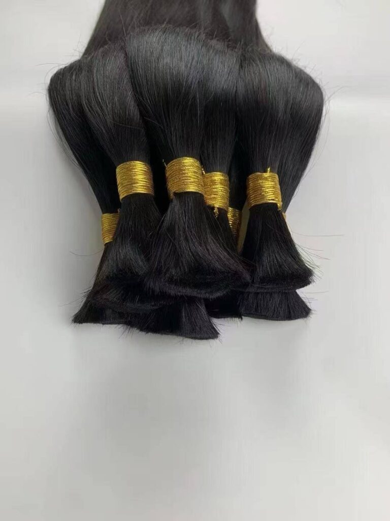 Close-up of thick strand virgin human hair bulk demonstrating the exceptional strength required by professional wig makers.