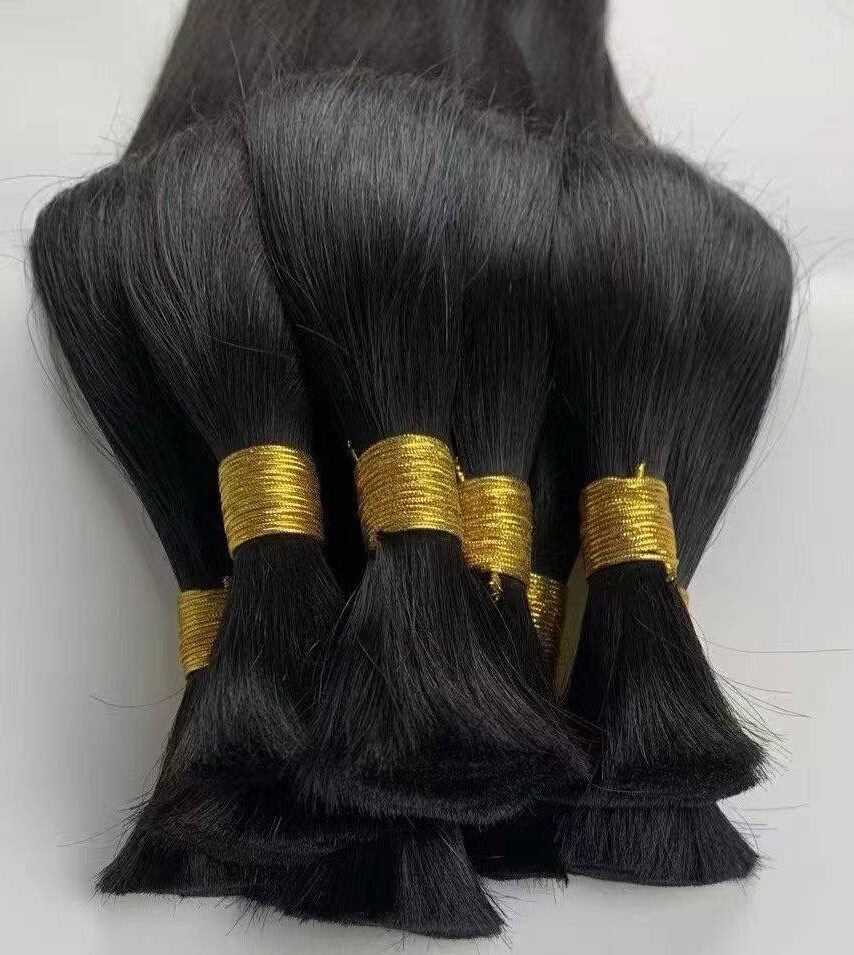 Close-up of thick strand virgin human hair bulk demonstrating the exceptional strength required by professional wig makers.
